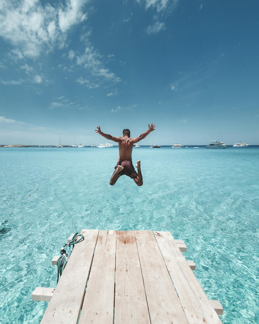 Spain summer - Man Jumping From the Dock into the Sea -  Melhores destinos na Espanha