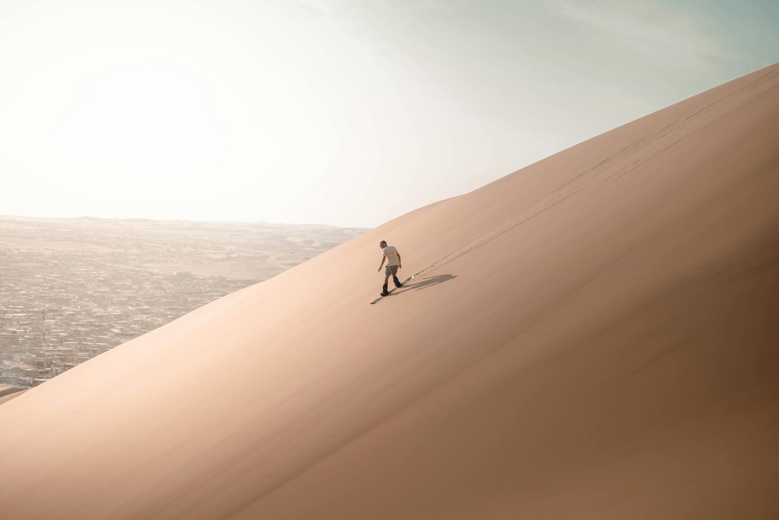 Man Sliding on Desert Dune
