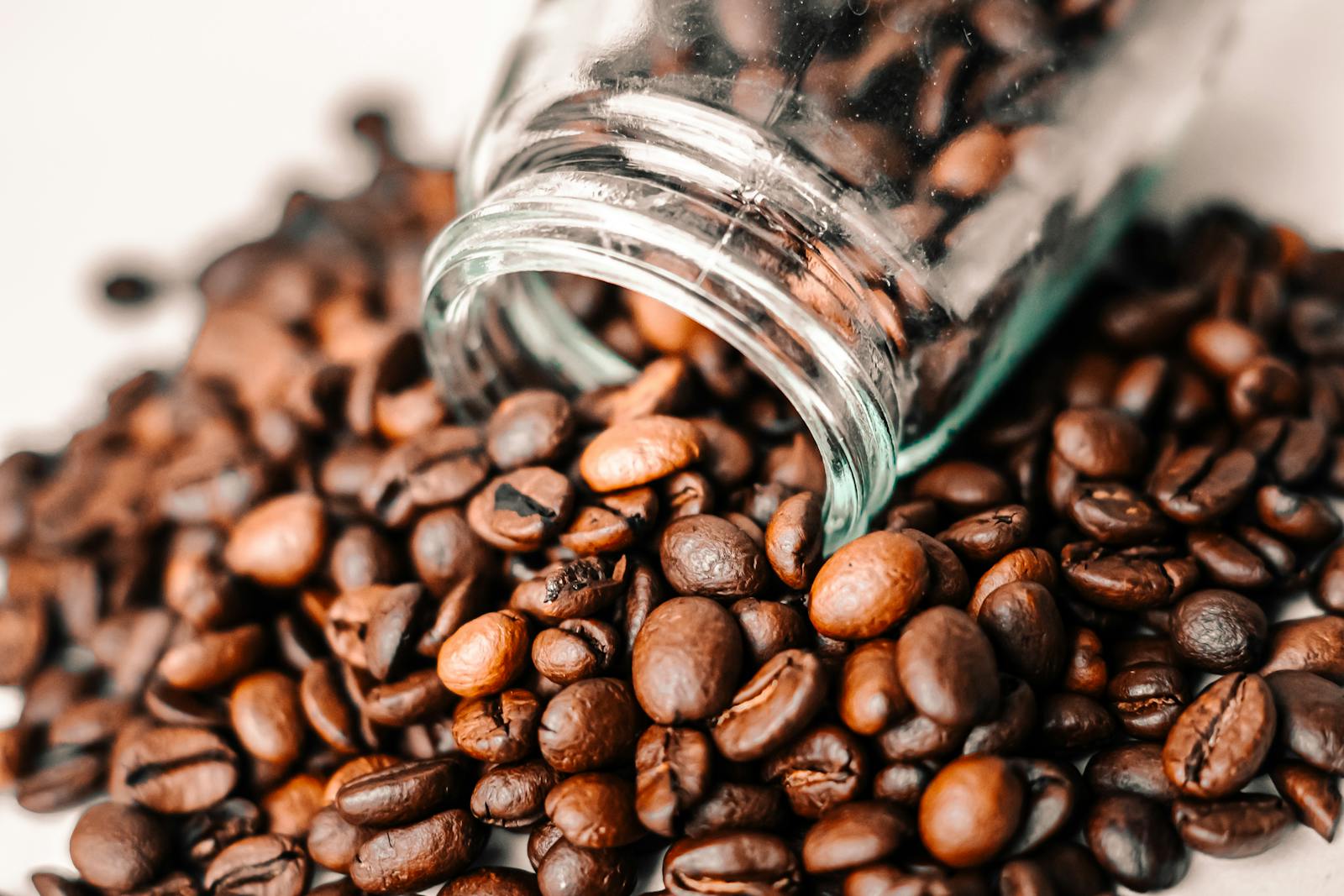 Coffee beans spilling out of a jar