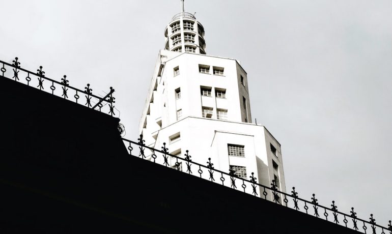 us a flag on top of white building - Bares Rooftop São Paulo