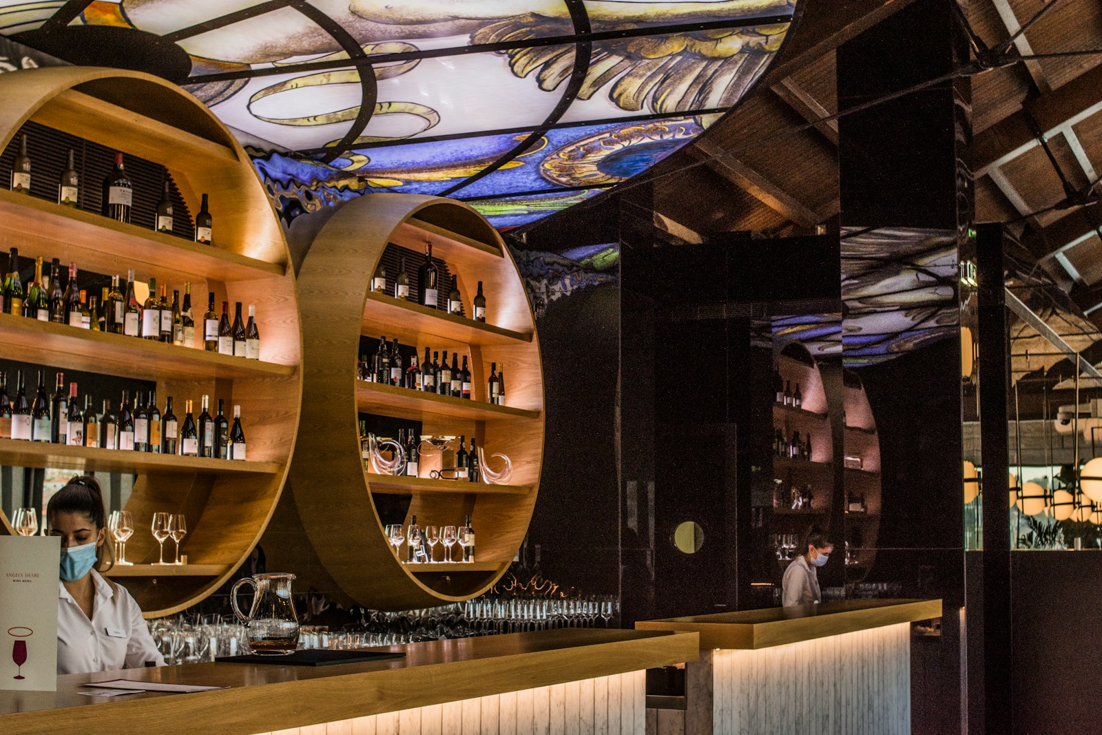 brown wooden shelf with glass bottles - Viagem gastronômica no Porto